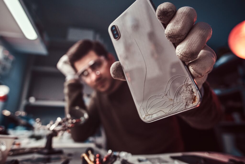 electronic technician repair damaged smartphone in the workshop