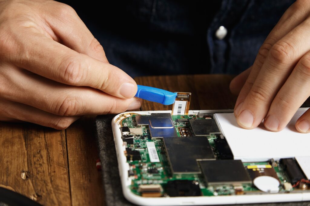 pro uses special plastic opener unclip electronic cord from motherboard gadget repairing fixing service lab